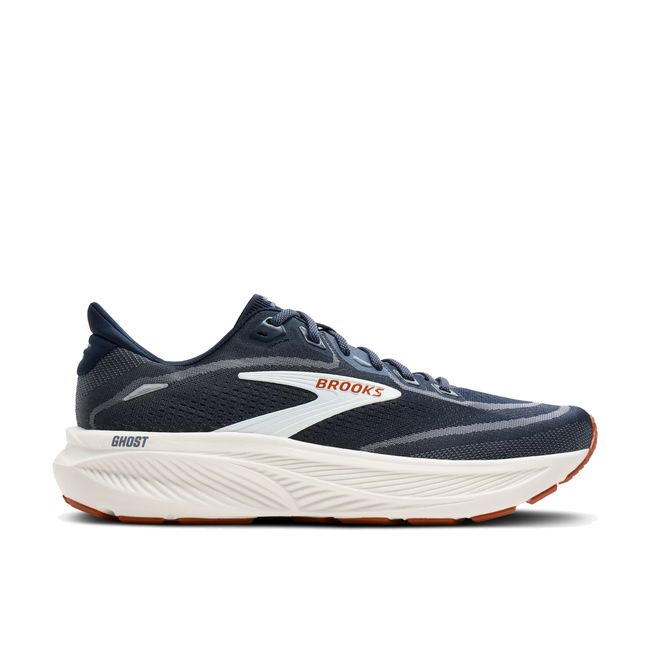 Lateral profile of Brooks Ghost 18 men's shoe in navy showing cream cushioned midsole and gum RoadTack outsole