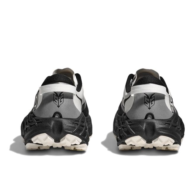 Heel pair view of Hoka Speedgoat 7 in black and white showing gaiter integration