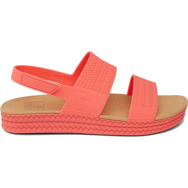 Lateral side of Women's Reef Water Vista Sandal in Sunset Coral with velcro backstrap