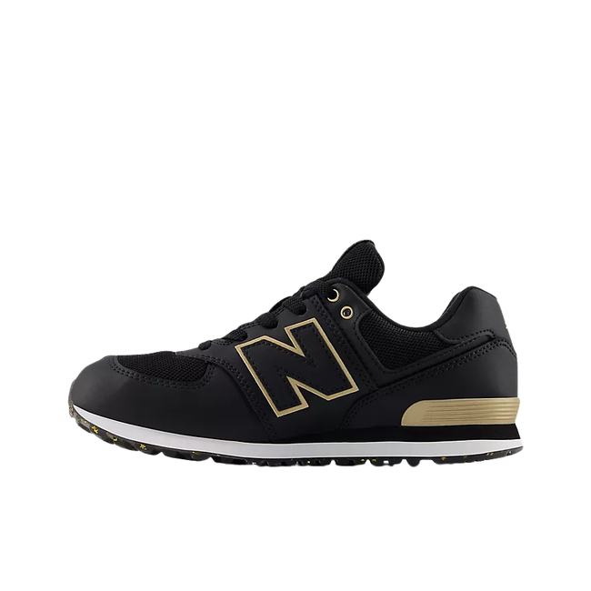 Medial side of New Balance Kids' 574 Lifestyle Shoe (Toddler/Little Kid) in Black with Gold