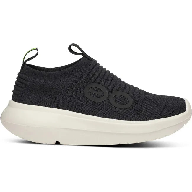 Lateral side of Women's OOfos OOmy Zen Sneaker in Black and Chalk white