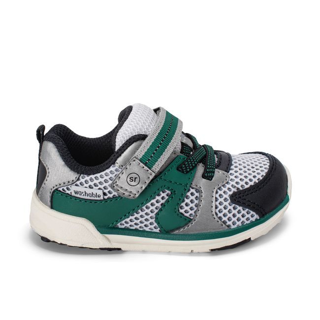 Right side profile of the Stride Rite Velocity in black and forest green with a cream sole