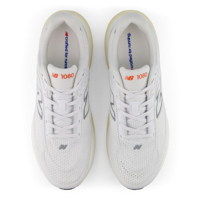 New Balance 1080 V15 running shoe in white and orange, top-down view.