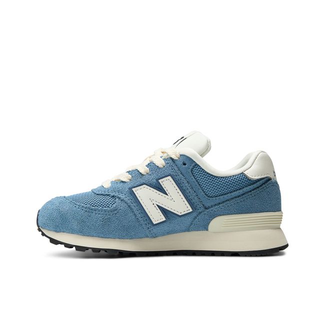Medial profile of the New Balance Kids' 574 in dusty blue suede and mesh